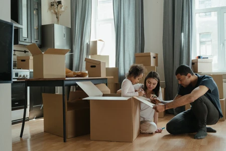 family packing boxes in home